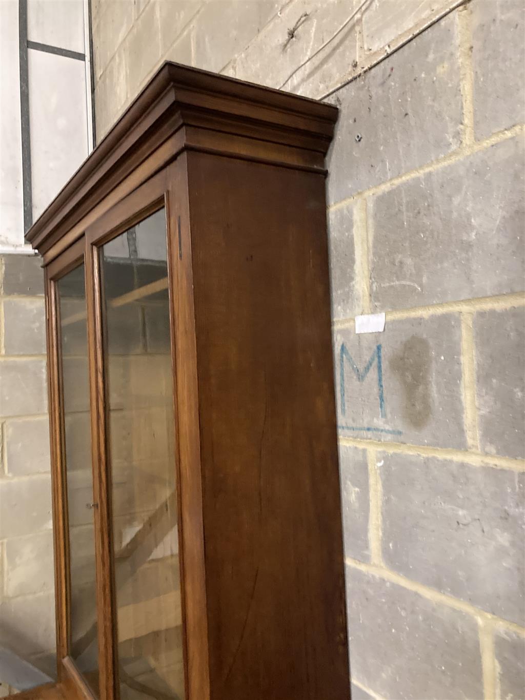 A late 19th century panelled oak library bookcase, length 118cm, depth 47cm, height 223cm